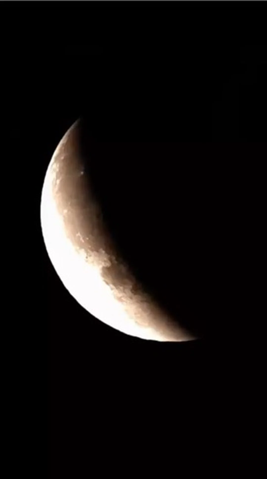 Crescent Moon with craters visible along the terminator