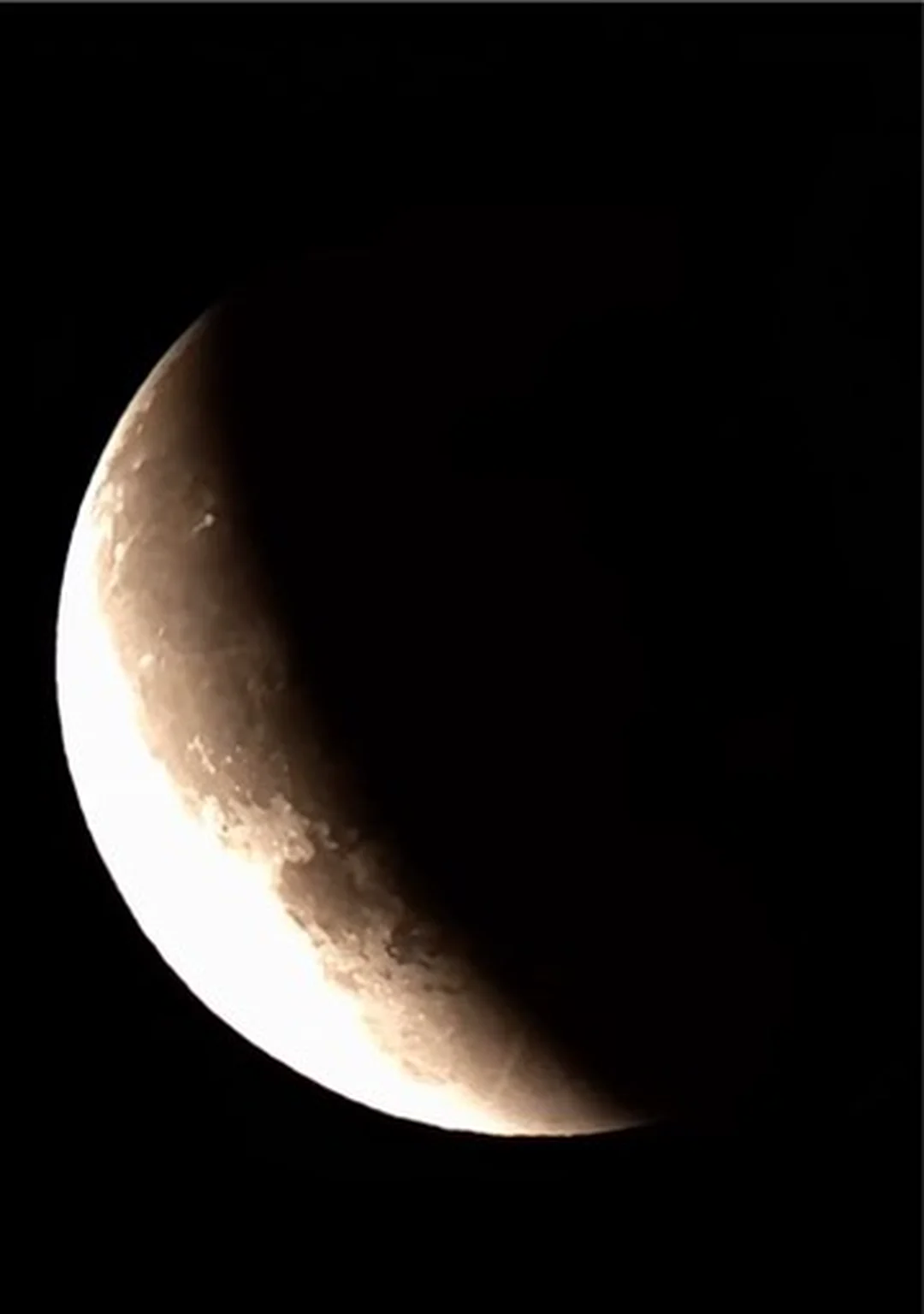 Close crescent Moon view with the terminator crossing lunar maria