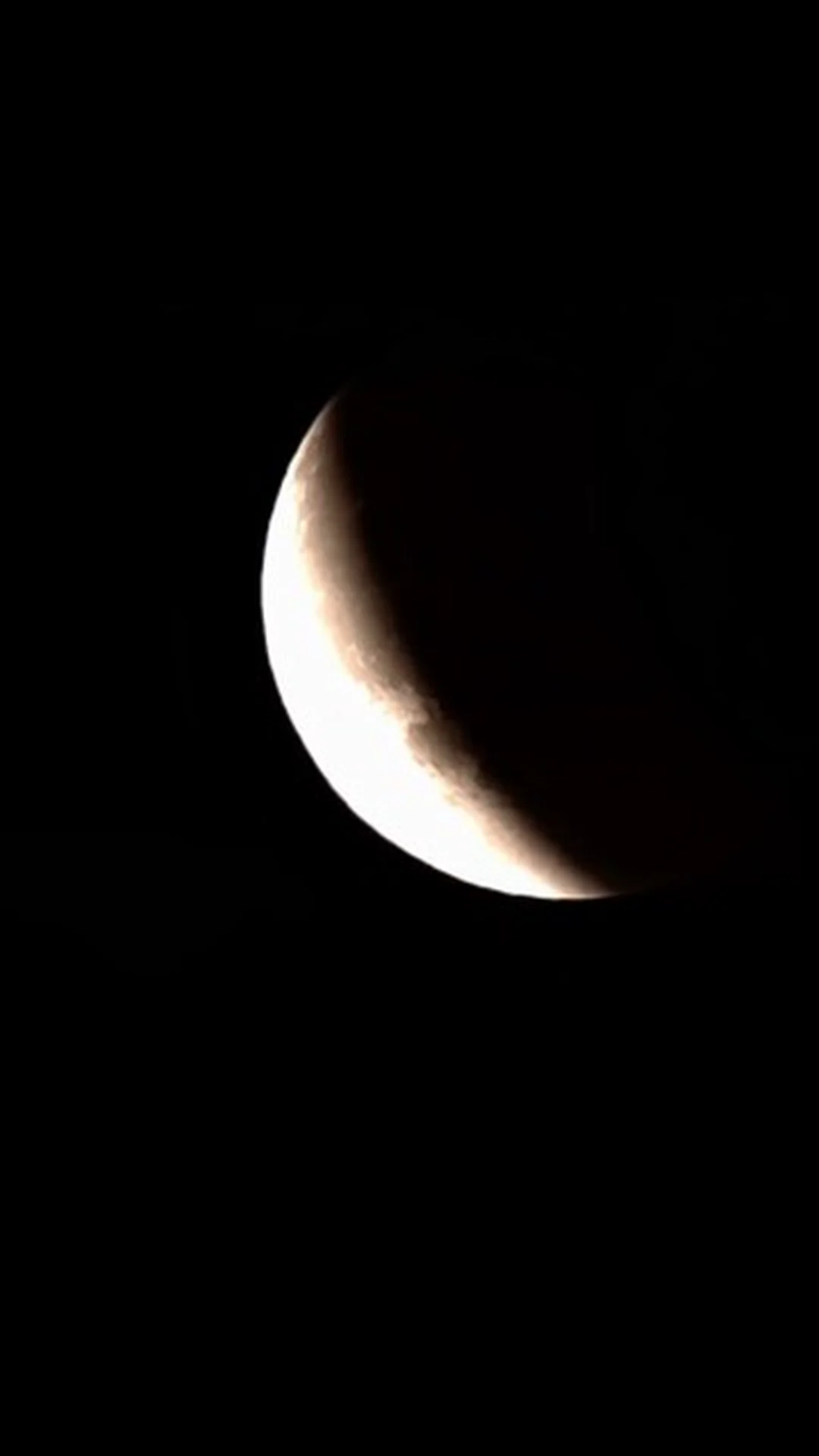 Small crescent Moon photographed against a black sky