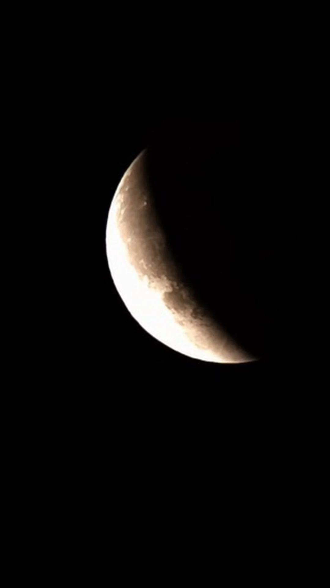 Crescent Moon with a bright sunlit limb and visible surface detail