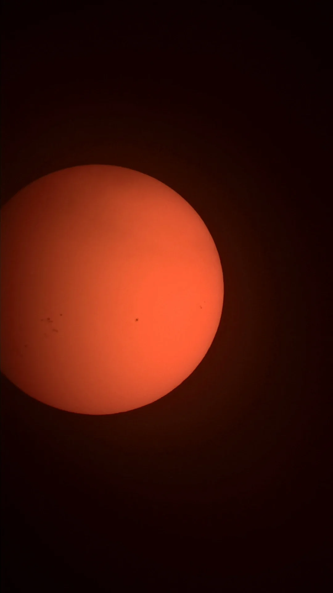 Filtered view of the Sun with several visible sunspots